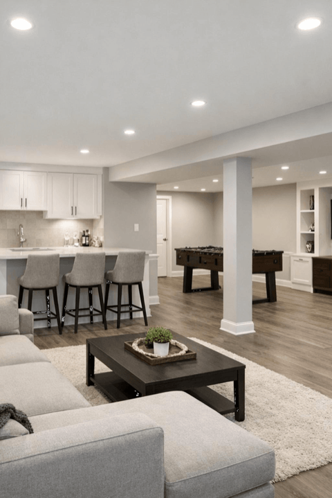 Basement before-and-after finishing example with lighting and floor upgrades